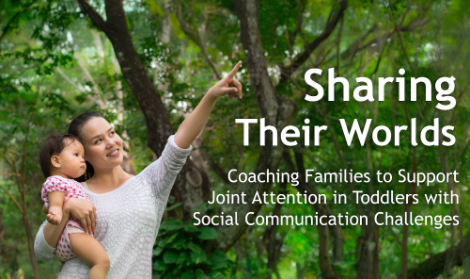 A parent with child pointing and smiling