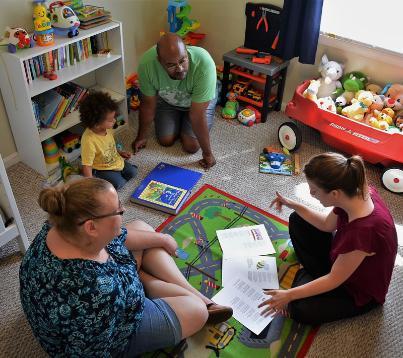 A family works with an early intervention coach.