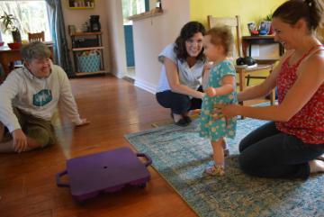 Early Intervention Specialist working with toddler and family of toddler