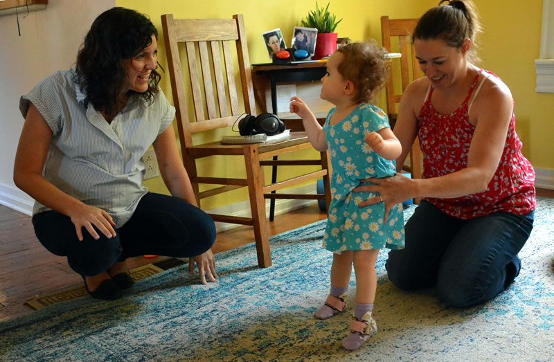 Parent and Early Intervention Specialist working with a toddler